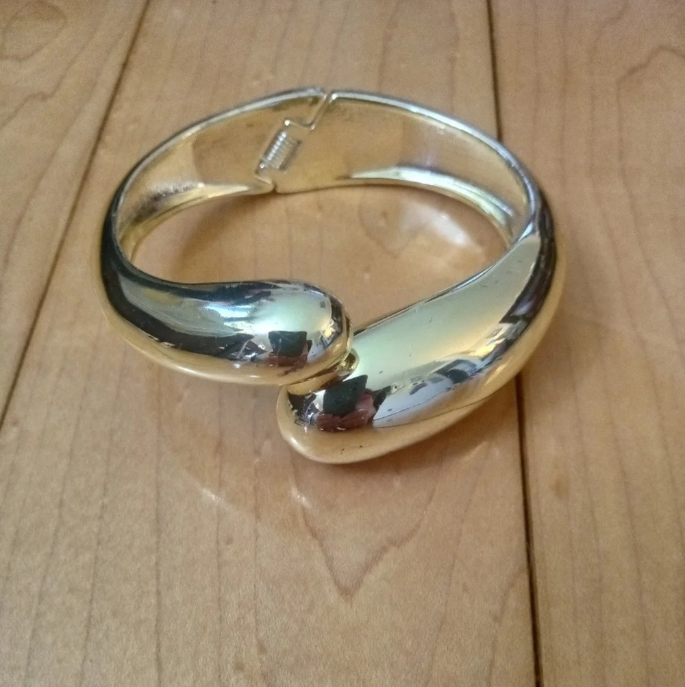 Gold tone spring loaded bracelet